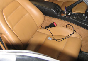 Tune cable routed by passenger seat