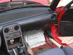 Pull back carpet to reveal the ECU cover panel.